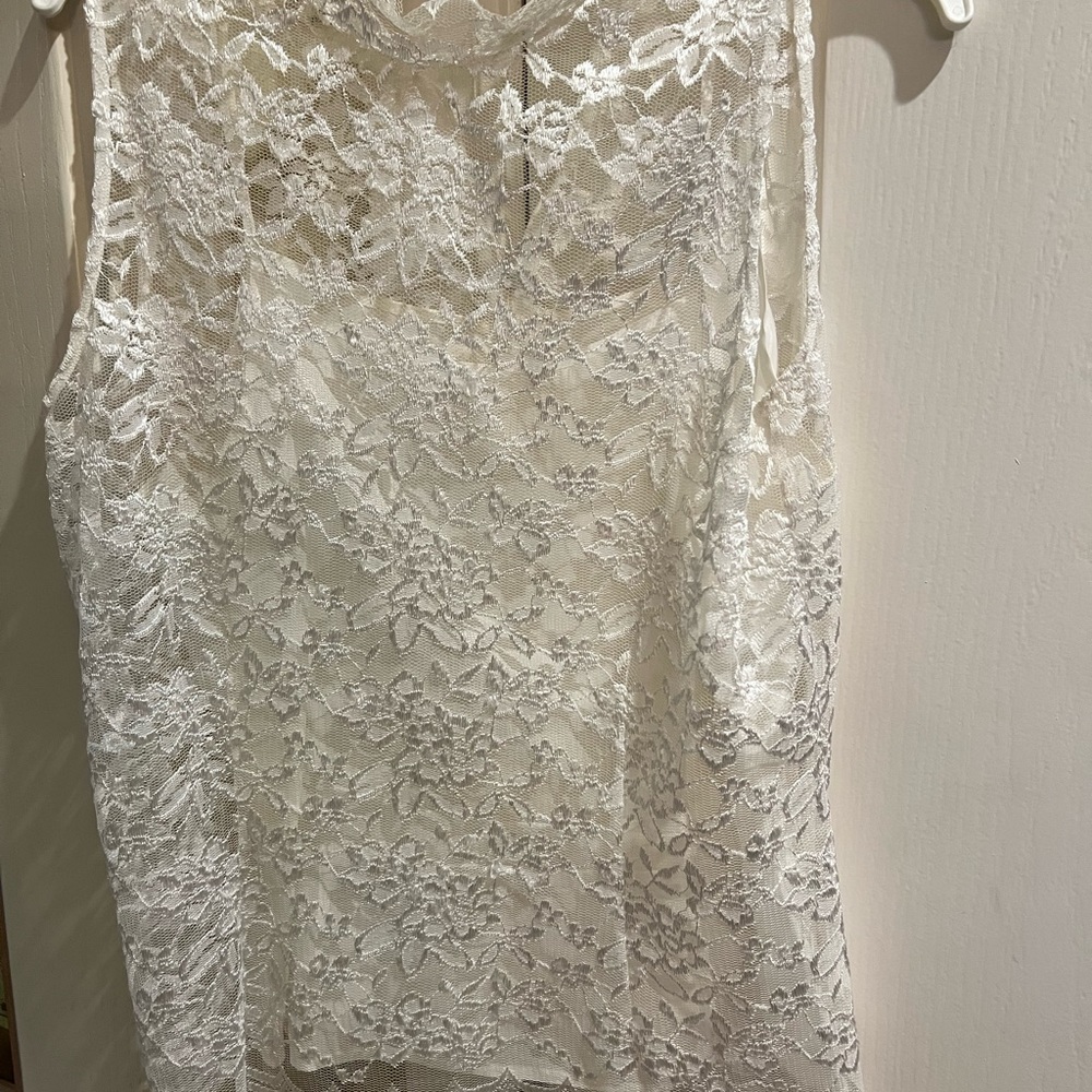 Neiman Marcus exclusive size 8 lace top with cami. Discoloration on neck.